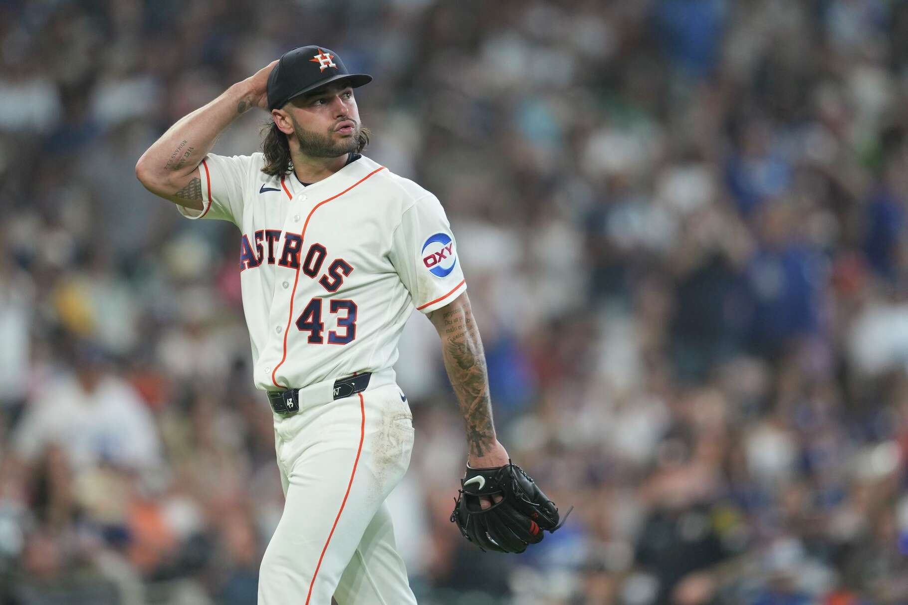 Houston Astros starting pitcher Lance McCullers Jr. looks back at the scoreboard as he walks off the field after being pulled in the third inning of an MLB baseball game on Wednesday, May 6, 2026.