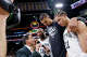 San Antonio Spurs forward Victor Wembanyama (1) hugs teammates San Antonio Spurs forward Carter Bryant (11) and San Antonio Spurs center Bismack Biyombo (18) while talking to reporters after their Game 2 win of the Western Conference semifinals at Frost Bank Center in San Antonio, Wednesday, May 6, 2026. The Spurs rolled past the Timberwolves 133-95 to even the series at 1-1.