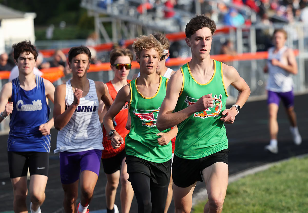 Southwestern junior Thor Springman has broken school records in the 1,600 and 3,200 meters, but still waiting his turn by Gillespie senior Chaz Oberkfell.