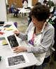 Margie Chase shows off her linocut print during artist Bill Pangburn's workshop at the Art Museum of Southeast Texas, May 2.
