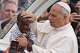 FILE - Pope Leo XIV blesses a child at the end of a Mass for the Jubilee of Migrants and Missionaries in St. Peter's Square at the Vatican, Sunday, Oct. 5, 2025.