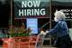 FILE - Hiring sign for sales professionals is displayed at a store, in Vernon Hills, Ill., Wednesday, April 15, 2026.