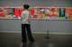 A woman looks at "F-111" an artwork of American artist James Rosenquist as she visits an exhibition called: "Art & war" displaying some artworks of American pop artists at the Tehran Museum of Contemporary Art in Iran, Thursday, May 7, 2026.