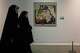Iranian women walk past American artist Roy Lichtenstein's "Brattata" as they visit an exhibition called: "Art & war" displaying some artworks of American pop artists at the Tehran Museum of Contemporary Art in Iran, Thursday, May 7, 2026.