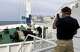A passenger of the hantavirus-hit cruise ship MV Hondius takes a photo of the ship's anchor as it sets sail in Praia, during the voyage to the Spanish port of Tenerife, May 6, 2026.