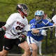 New Canaan's Matt Reed (98) carries the ball while Darien's Jack Hanley (32) defends during a boys lacrosse game in New Canaan on Saturday, May 2, 2026.