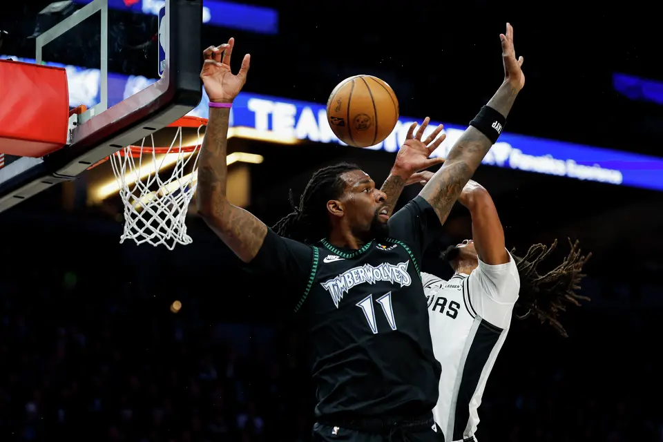 San Antonio Spurs guard Stephon Castle (5) and Minnesota Timberwolves center Naz Reid (11) collide at the basket during the first half of Game 3 of the Western Conference semifinals at Target Center in Minneapolis, Friday, May 8, 2026.