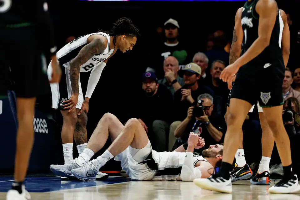 San Antonio Spurs center Luke Kornet (7) goes down on the court and is aided by teammate San Antonio Spurs guard Devin Vassell (24) during the first half of Game 3 of the Western Conference semifinals at Target Center in Minneapolis, Friday, May 8, 2026.