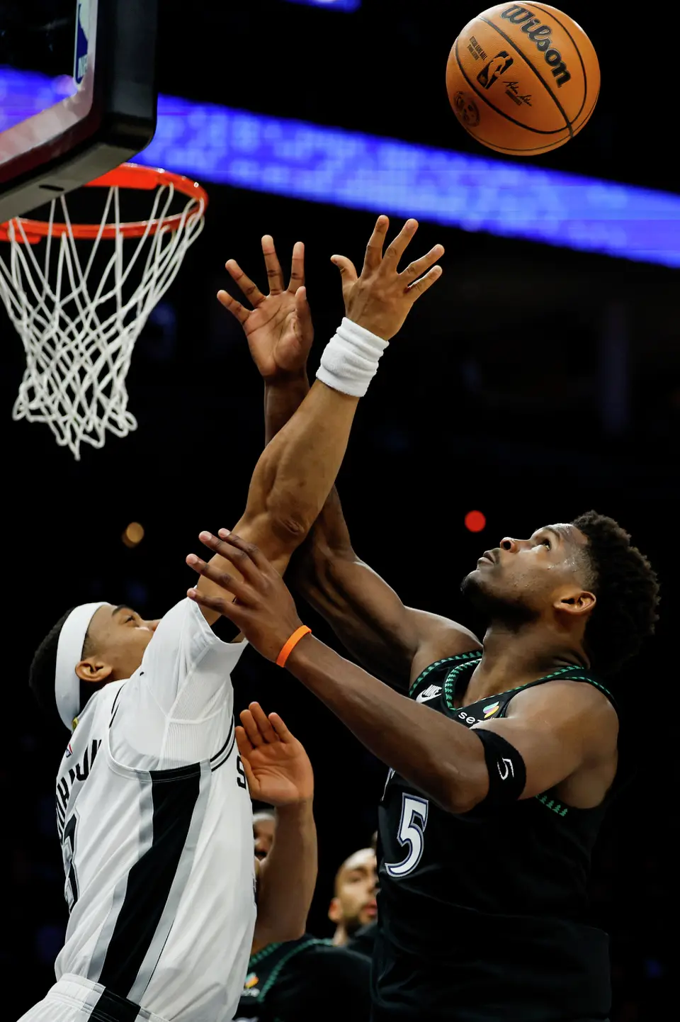 San Antonio Spurs forward Keldon Johnson (3) and Minnesota Timberwolves guard Anthony Edwards (5) reach for the ball during the first half of Game 3 of the Western Conference semifinals at Target Center in Minneapolis, Friday, May 8, 2026.
