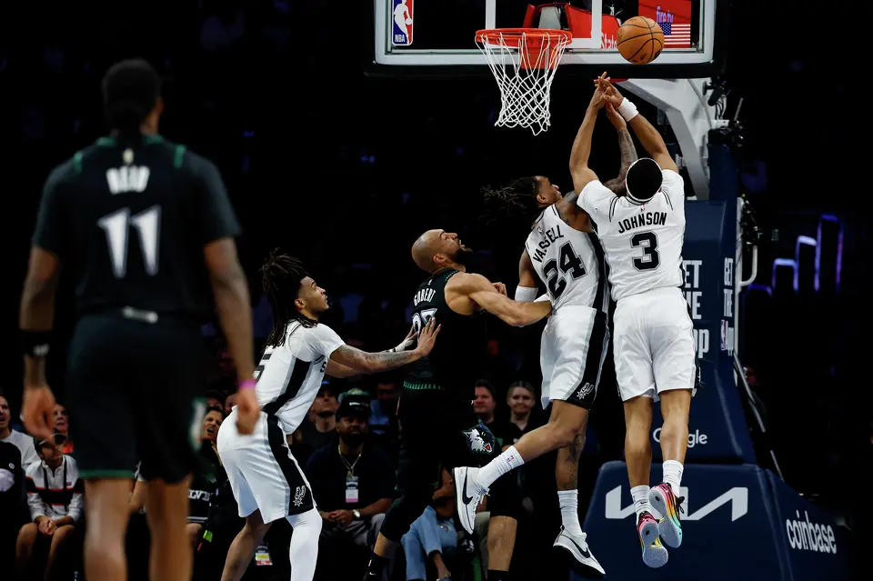San Antonio Spurs forward Keldon Johnson (3) and San Antonio Spurs guard Devin Vassell (24) reach for the ball during the first half of Game 3 of the Western Conference semifinals at Target Center in Minneapolis, Friday, May 8, 2026.