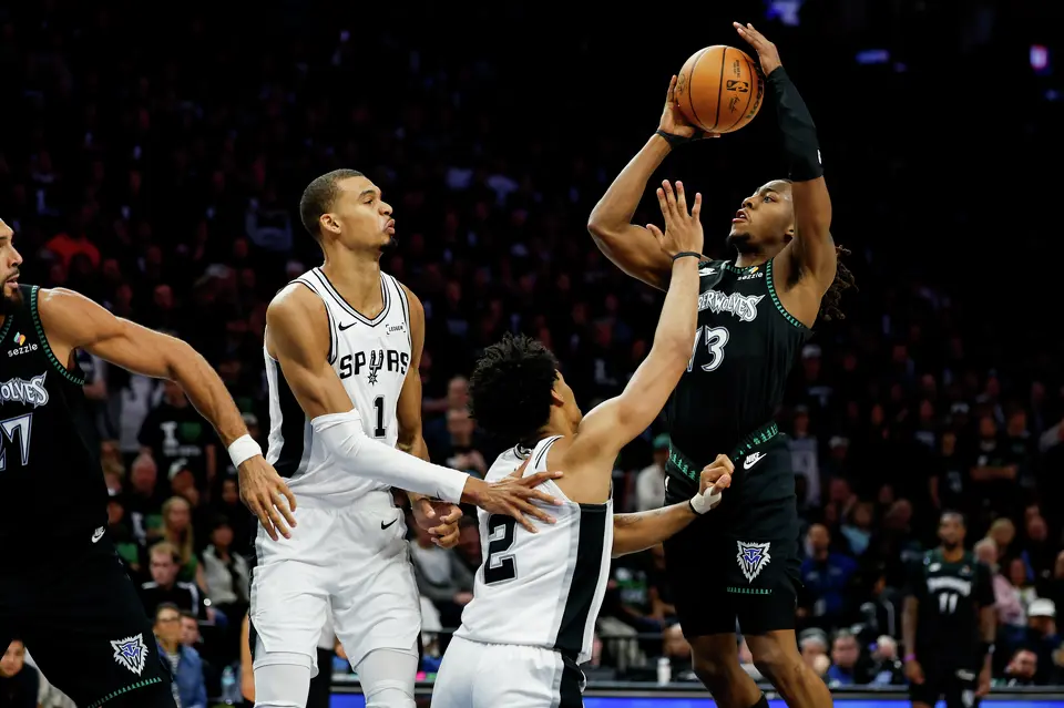 Minnesota Timberwolves guard Ayo Dosunmu (13) goes up for a shot while guarded by San Antonio Spurs guard Dylan Harper (2) and San Antonio Spurs forward Victor Wembanyama (1) during the second half of Game 3 of the Western Conference semifinals at Target Center in Minneapolis, Friday, May 8, 2026. The Spurs defeated the Timberwolves 115-108, leading the series 2-1.