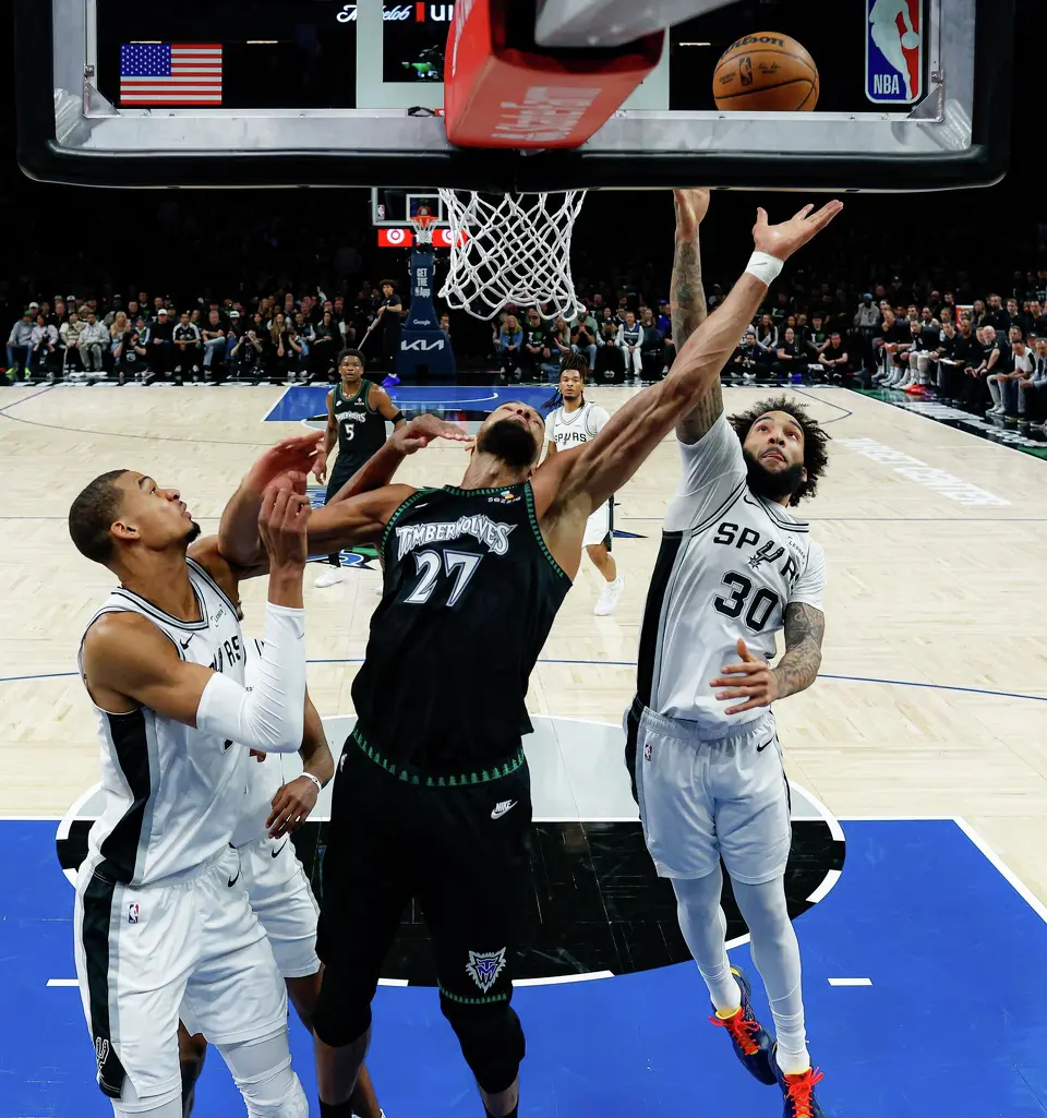 San Antonio Spurs forward Victor Wembanyama (1) and forward Julian Champagnie (30) block Minnesota Timberwolves center Rudy Gobert (27) under the net during the first half of Game 3 of the Western Conference semifinals at Target Center in Minneapolis, Friday, May 8, 2026. The Spurs defeated the Timberwolves 115-108, leading the series 2-1.