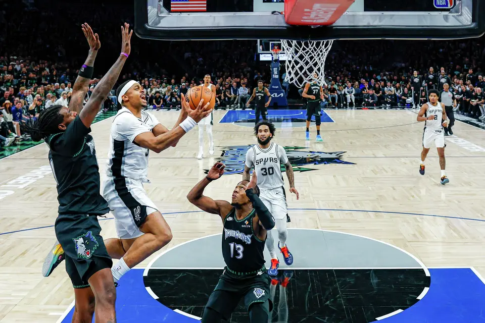 San Antonio Spurs forward Keldon Johnson (3) leaps towards the net around the Minnesota Timberwolves defense during the second half of Game 3 of the Western Conference semifinals at Target Center in Minneapolis, Friday, May 8, 2026. The Spurs defeated the Timberwolves 115-108, leading the series 2-1.