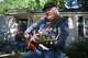 Steve Fowler, a Beale Street musician whose street was bisected by Tennessee's new congressional districts, strums the guitar in his front yard on Thursday, May 7, 2026, in Memphis, Tenn.
