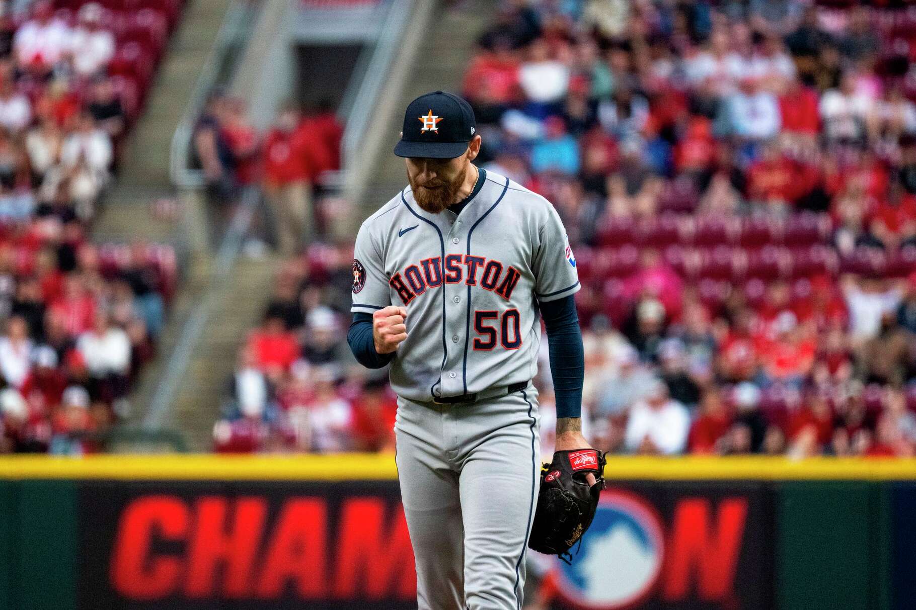 Houston Astros pitcher Mike Burrows reacts after preventing a run in the fourth inning of a baseball game against the Cincinnati Reds, Friday, May 8, 2026, in Cincinnati. (AP Photo/Michael Swensen)
