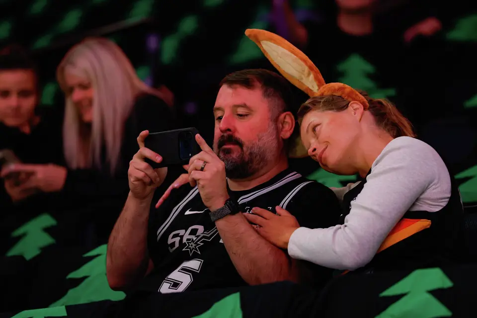 Andrey and Anneli Guajardo watch San Antonio Spurs forward Victor Wembanyama warm up on the court before Game 4 of the Western Conference semifinals at Target Center in Minneapolis on Sunday, May 10, 2026. Andrey is from South Texas and the couple now lives in Minnesota.