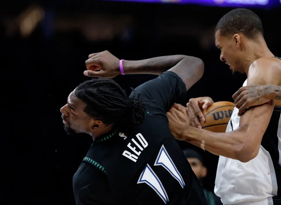 San Antonio Spurs forward Victor Wembanyama (1) fights for a rebound before drawing a flagrant fowl charge after throwing an elbow to the face of Minnesota Timberwolves center Naz Reid (11) leading to his ejection in the 2nd quarter of Game 4.