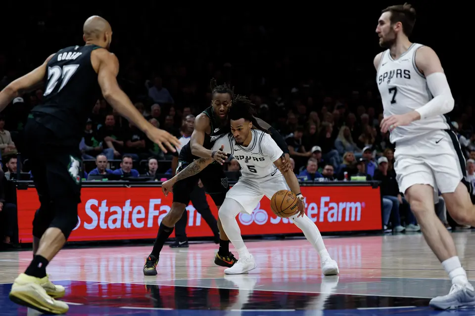 San Antonio Spurs guard Stephon Castle (5) drives past Minnesota Timberwolves guard Ayo Dosunmu (13) during the first half of Game 4 of the Western Conference semifinals at Target Center in Minneapolis on Sunday, May 10, 2026.