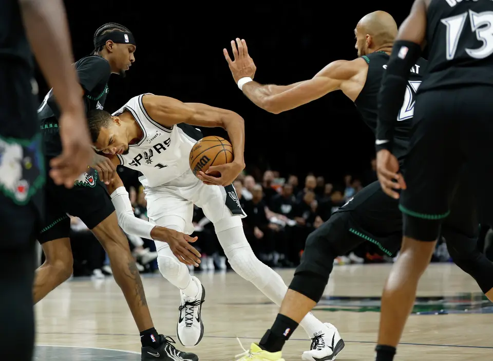 San Antonio Spurs forward Victor Wembanyama (1) runs into Minnesota Timberwolves forward Jaden McDaniels (3) while trying to drive to the basket during the first half of game 4 on Sunday, May 10, 2026 in Minneapolis.