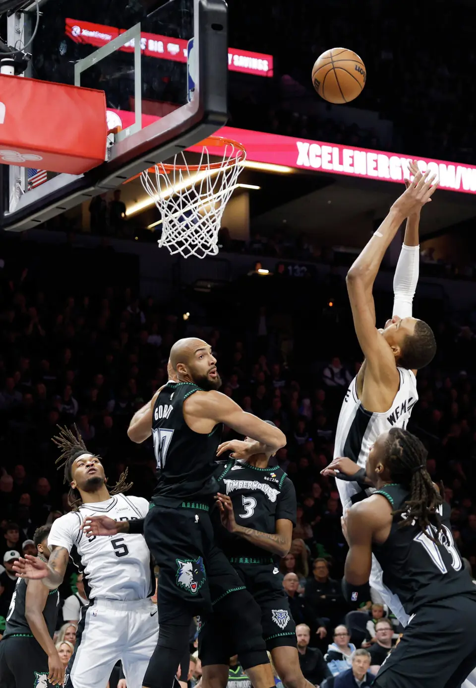 San Antonio Spurs forward Victor Wembanyama (1) tries to pull down the rebound over Minnesota Timberwolves center Rudy Gobert (27) during the first half of Game 4 of the Western Conference semifinals at Target Center in Minneapolis on Sunday, May 10, 2026.
