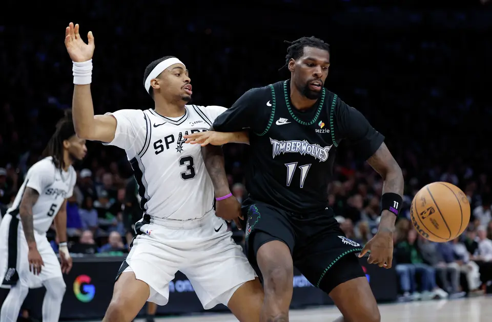 San Antonio Spurs forward Keldon Johnson (3) and Minnesota Timberwolves center Naz Reid (11) battle over a loose ball during the second half of Game 4 of the Western Conference semifinals at Target Center in Minneapolis on Sunday, May 10, 2026. The Spurs lost to the Timberwolves 114-109, tying the series at 2-2.