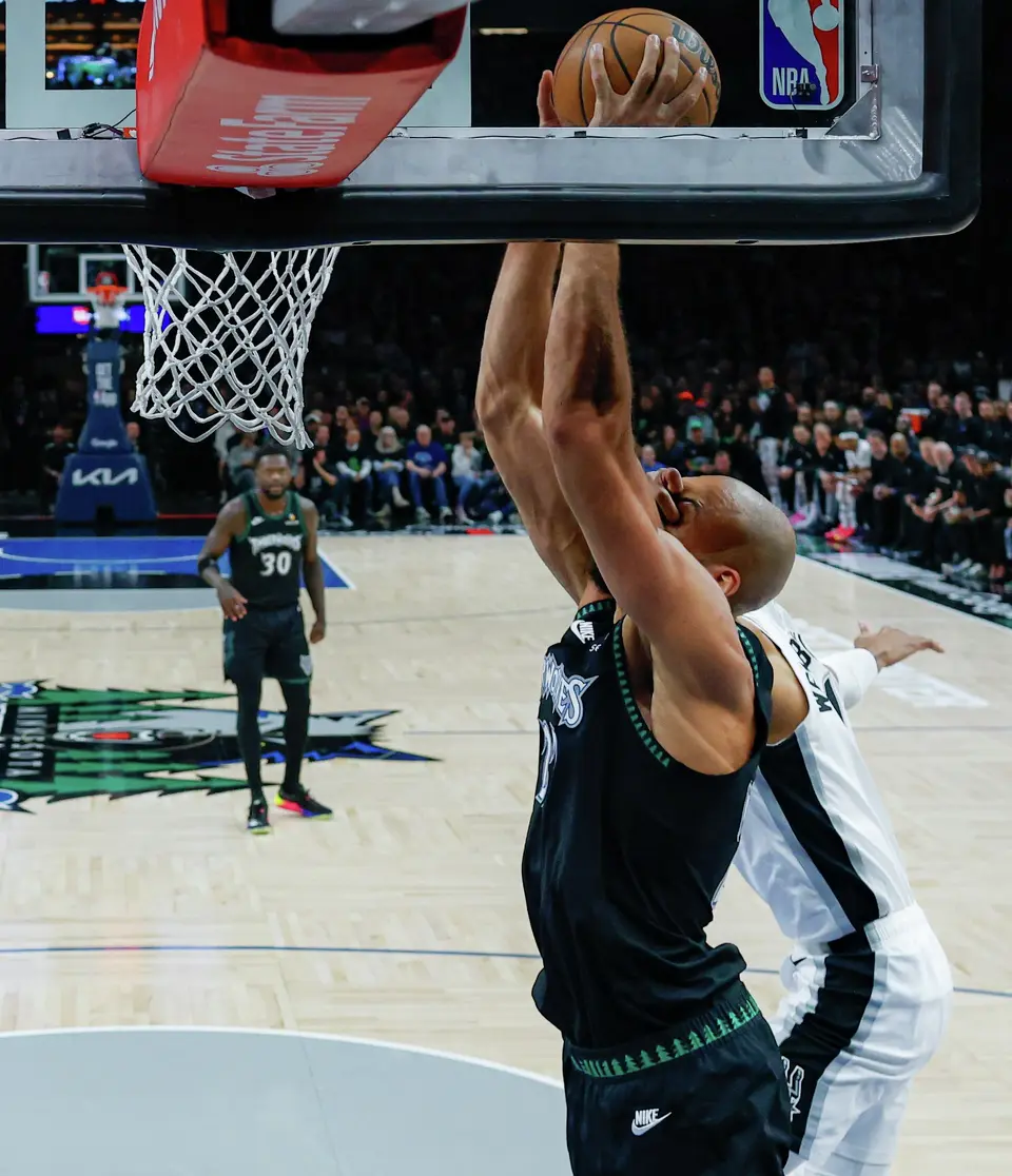 San Antonio Spurs forward Victor Wembanyama (1) fouls Minnesota Timberwolves center Rudy Gobert (27) as he goes up for a shot during the first quarter of Game 4 of the Western Conference semifinals at Target Center in Minneapolis on Sunday, May 10, 2026. The Spurs lost to the Timberwolves 114-109, tying the series at 2-2.