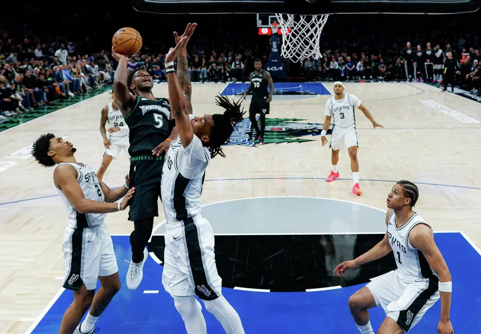 Minnesota Timberwolves guard Anthony Edwards (5) goes up for a shot over San Antonio Spurs guard Dylan Harper (2) and guard Stephon Castle (5) during Game 4 of the Western Conference semifinals at Target Center in Minneapolis on Sunday, May 10, 2026. The Spurs lost to the Timberwolves 114-109, tying the series at 2-2.