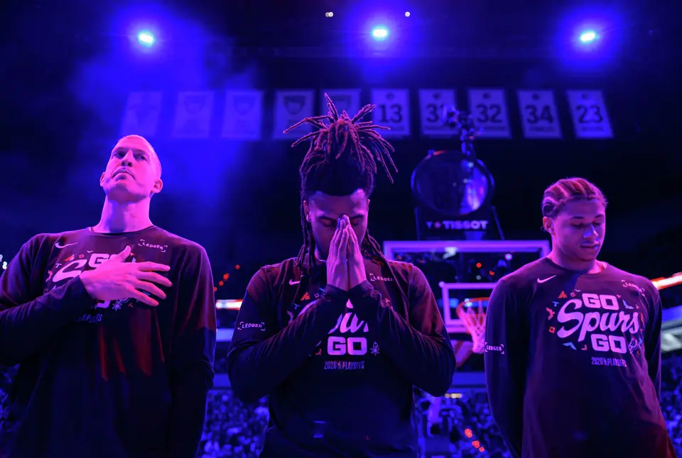 San Antonio Spurs center Mason Plumlee, from left, guard Stephon Castle, left, and forward Carter Bryant stand for the national anthem before Game 4 of the Western Conference semifinals against the Minnesota Timberwolves at Target Center in Minneapolis, Sunday, May 10, 2026.