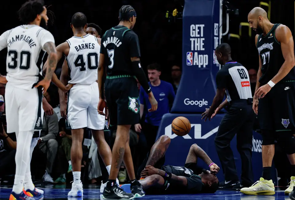 Minnesota Timberwolves center Naz Reid (11) reacts after colliding with San Antonio Spurs center Luke Kornet (7) while defending him under the net during the second half of Game 4 of the Western Conference semifinals at Target Center in Minneapolis on Sunday, May 10, 2026. The Spurs lost to the Timberwolves 114-109, tying the series at 2-2.