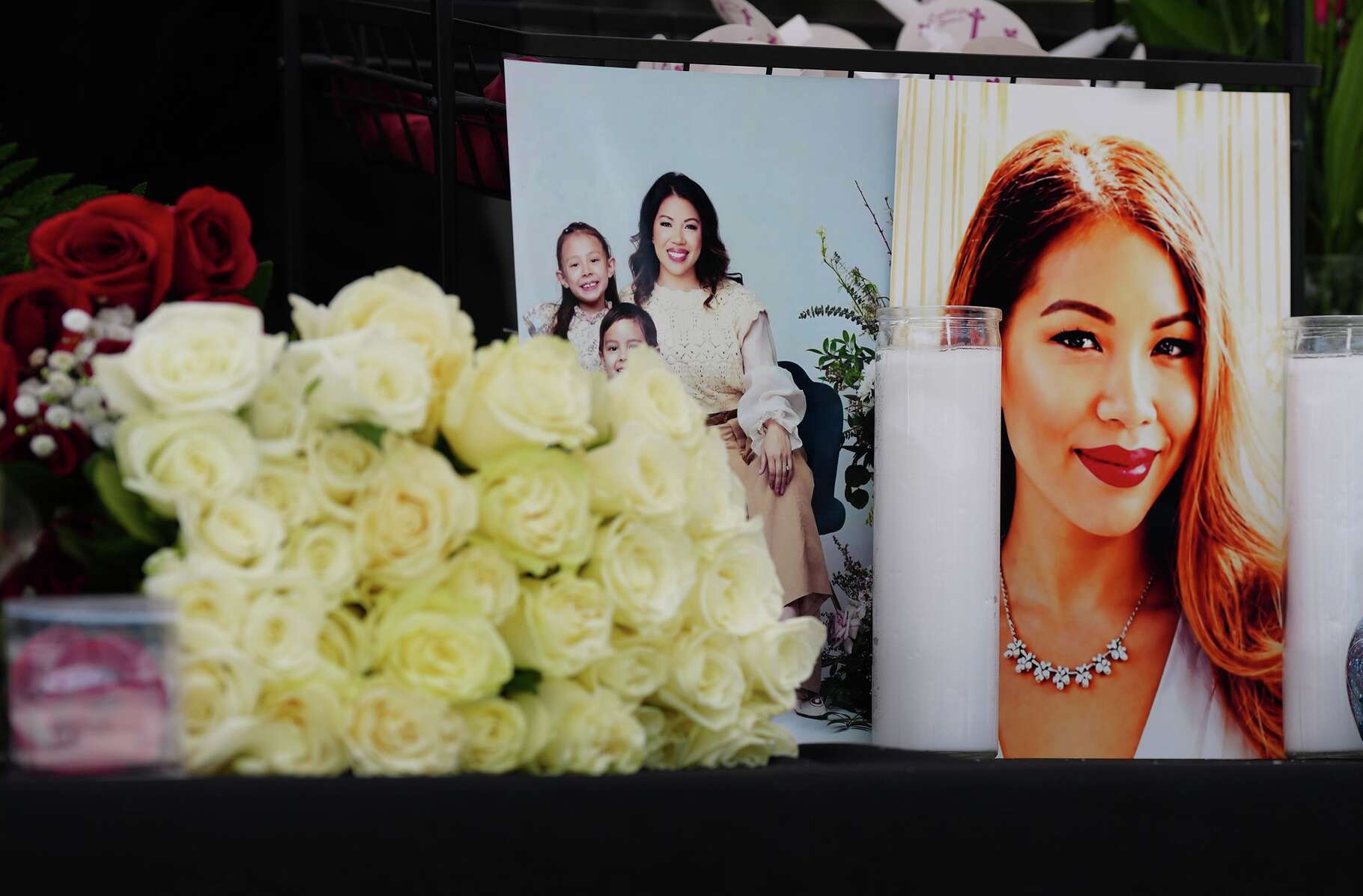 Photos of Thy Mitchell and her children are placed on a table with flowers and candels during a vigil at Traveler’s Cart in Houston on Monday, May 11, 2026.