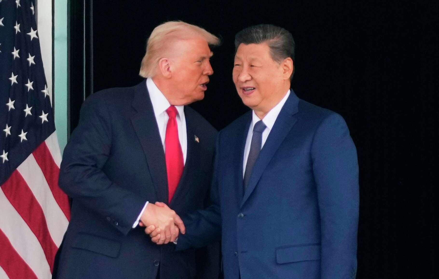 FILE - President Donald Trump, left, and Chinese President Xi Jinping, shake hands after their U.S.-China summit talk at Gimhae International Airport Jinping in Busan, South Korea, Oct. 30, 2025.