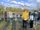 Orinthologist Joe Lipar (left) talks with a group of bird watchers Saturday, May 9 at Northend Park in Big Rapids.