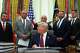 President Donald Trump turns to speak to Dr. Marty Makary, commissioner of the Food and Drug Administration, left, in the Oval Office of the White House, Saturday, April 18, 2026, in Washington.