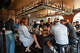 Customers crowd the modern U-shaped bar at Bar Underdog, where a long shelf holds over 100 bottles, in Palo Alto, Calif., on May 1, 2026.