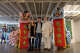 Charles Linder, Thomasina DeMaio and a friend pose with lion dancers at the American Messenger art gallery in San Francisco on Thursday, May 7, 2026.