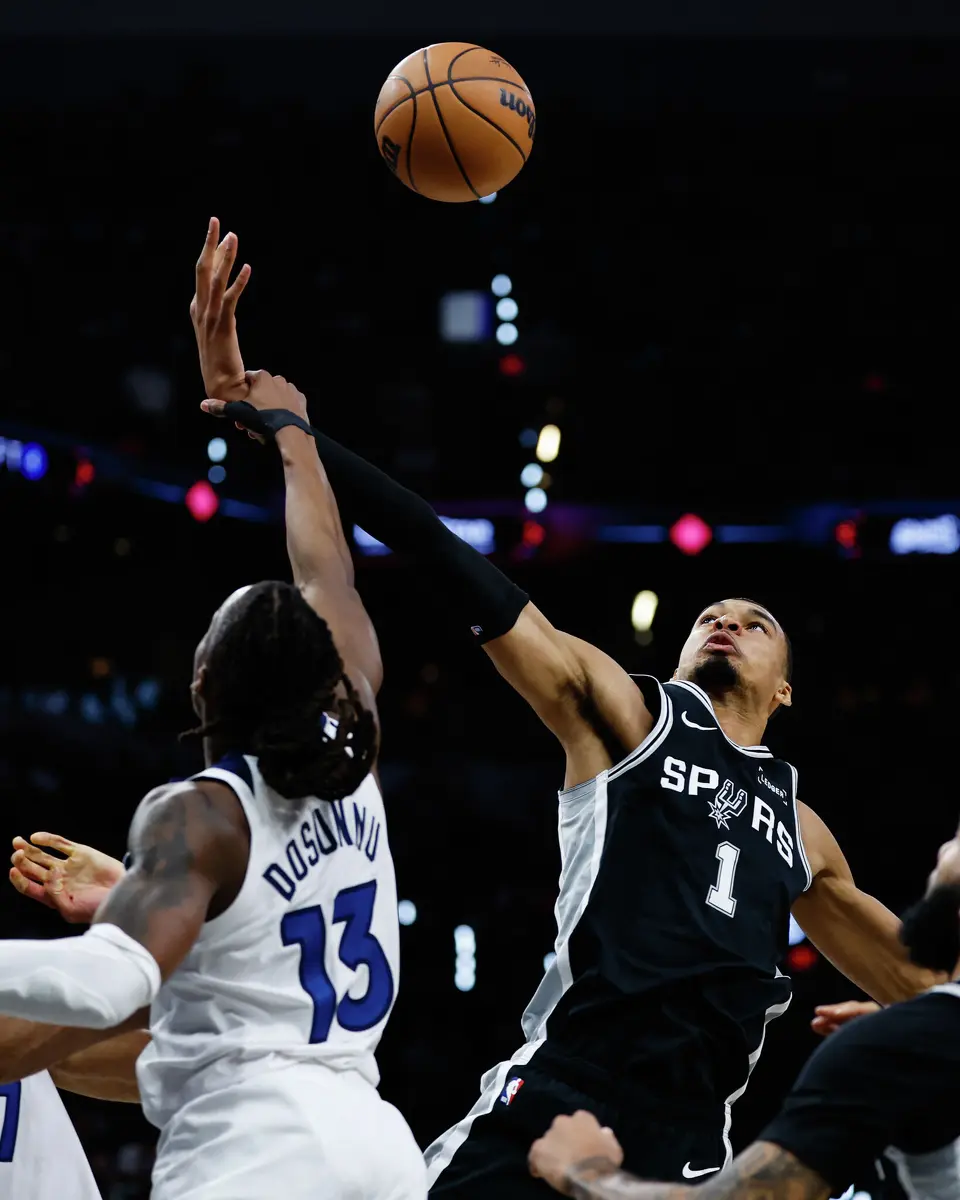 Minnesota Timberwolves guard Ayo Dosunmu (13) grabs San Antonio Spurs forward Victor Wembanyama (1) during the first half of Game 5 of the Western Conference semifinals at Frost Bank Center in San Antonio, Tuesday, May 12, 2026.
