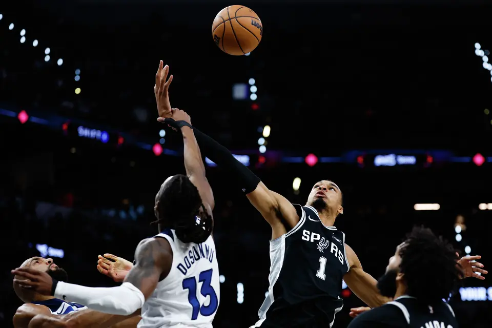 Minnesota Timberwolves guard Ayo Dosunmu (13) grabs San Antonio Spurs forward Victor Wembanyama (1) during the first half of Game 5 of the Western Conference semifinals at Frost Bank Center in San Antonio, Tuesday, May 12, 2026.