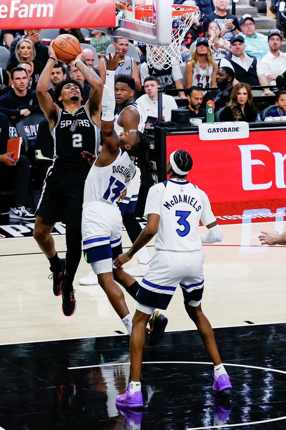 San Antonio Spurs guard Dylan Harper (2) goes up for a shot over Minnesota Timberwolves guard Ayo Dosunmu (13) during Game 5 of the Western Conference semifinals at Frost Bank Center in San Antonio, Tuesday, May 12, 2026. The Spurs defeated the Timberwolves 126-97, now leading the series 3-2.