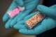 FILE - Jonathan Dumke, a senior forensic chemist with the Drug Enforcement Administration, holds vials of fentanyl pills at a DEA research laboratory on April 29, 2025, in Northern Virginia.