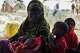 Abdi Ahmed Farah's wife, Absheera Ali, sits with her children outside their home in Usgure, Puntland, Somalia, Wednesday, April 15, 2026.