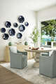 An expansive window frames the water view near the game table.