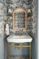 Sherwin-Williams’ Stardew is a calming choice for the lower wall treatment in this bath.