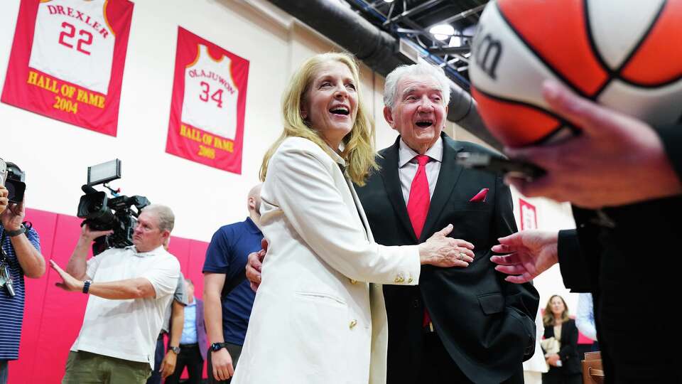 Paige Fertitta laughs with former Houston Comets coach Van Chancellor after a press conference regarding the return of the WNBA’s Houston Comets at the Toyota Center in Houston on Thursday, May 14, 2026.