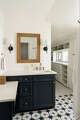 Bold, starburst tile shifts to a more subdued floor pattern beyond this bath, creating subtle contrast.