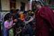 U.S.-born Buddhist lama Jalue Dorje smiles as he blesses people by tapping bowed heads with a ritual vase and a peacock feather at the end of 12 days of empowerments, or initiation rituals and teachings, bestowed by the abbot of Shechen Monastery in Kathmandu, Nepal, on Sunday, April 12, 2026.