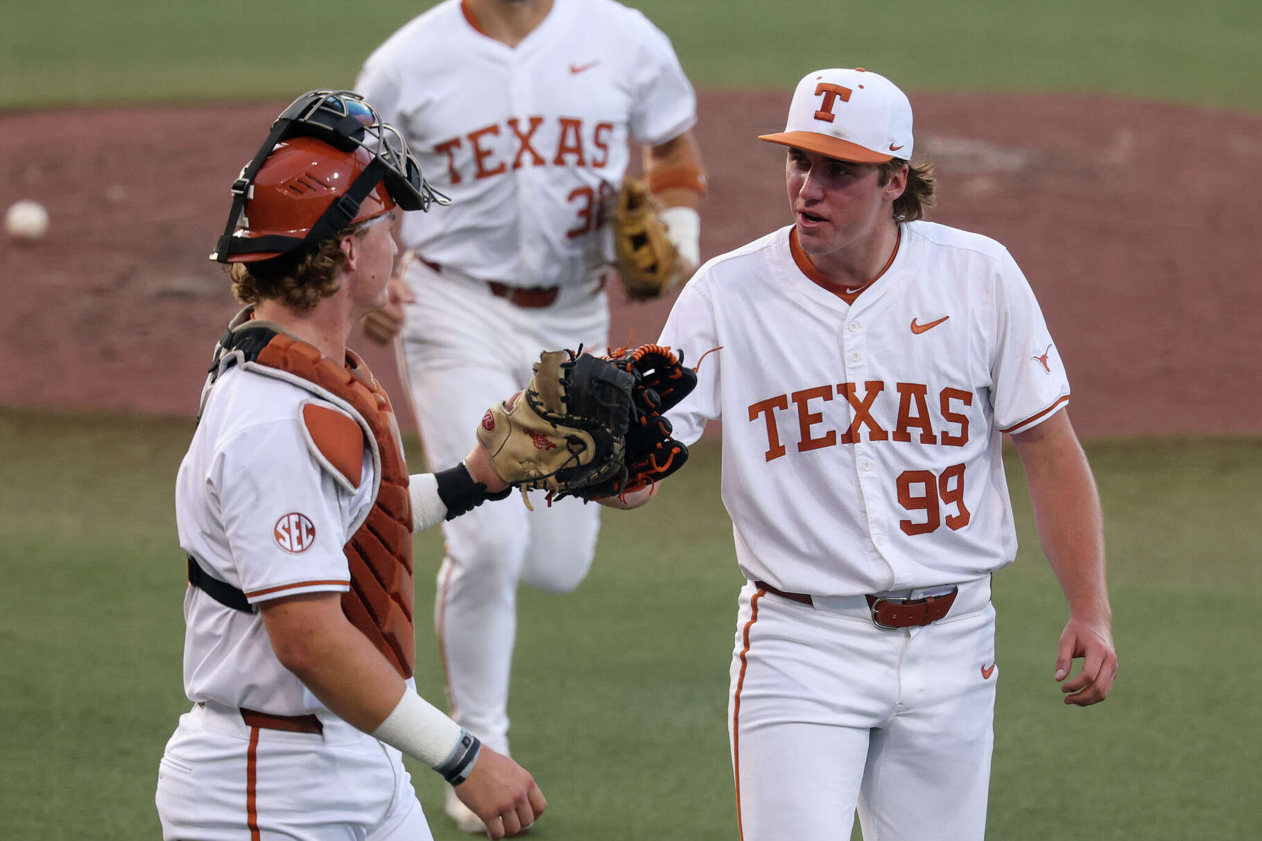 Texas pitcher Dylan Volantis gets a high five from catcher Carson Tinney in a win over Missouri.