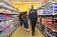San Antonio Spurs forward Harrison Barnes, front, and his wife Brittany Barnes walk through H-E-B as they host a holiday shopping spree for families in San Antonio, Texas, on November 20, 2025