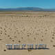 An aerial view of a bold text installation reading “THE END OF THE WORLD,” north of Twentynine Palms, Calif.