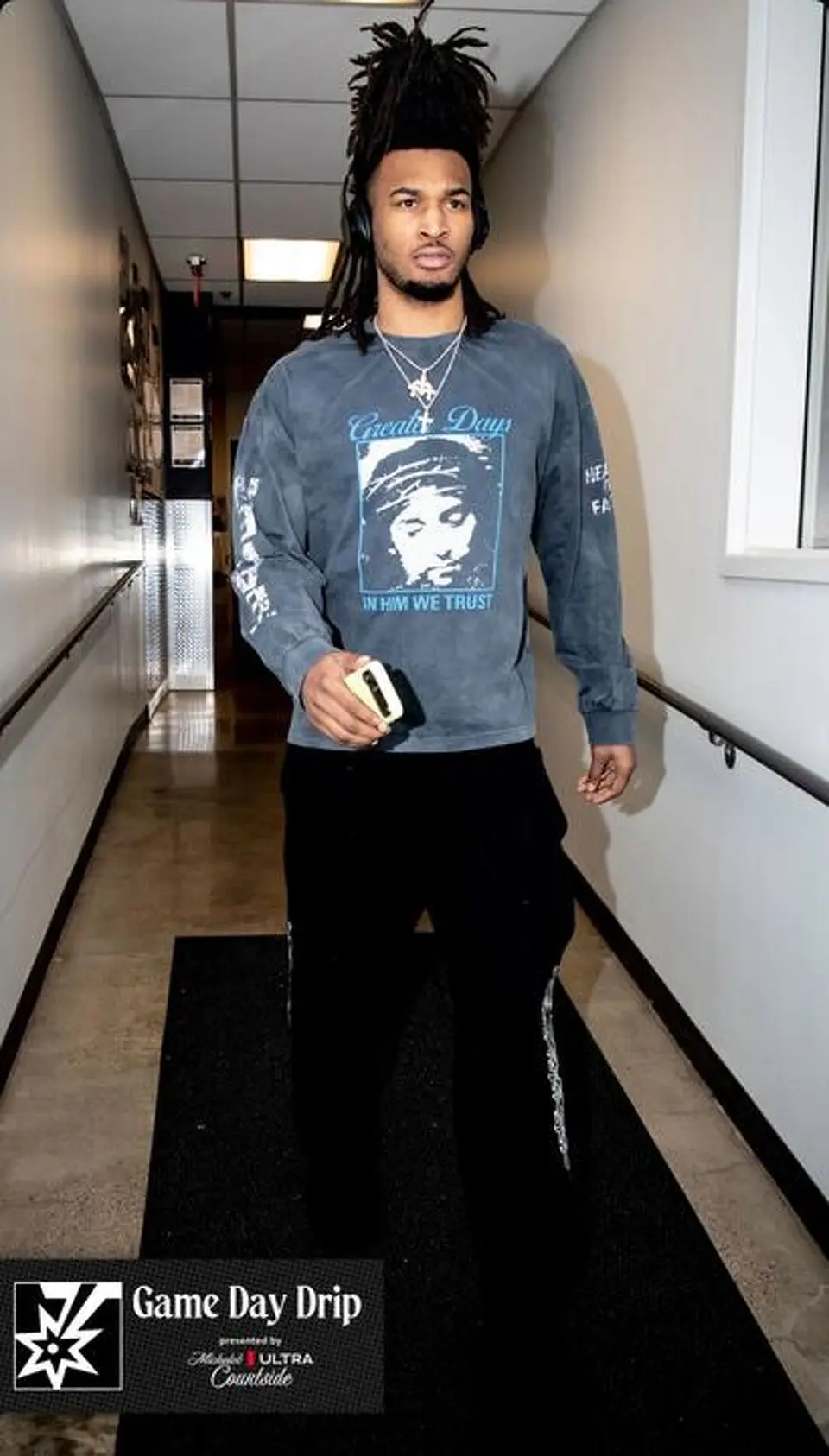 Stephon Castle arrives wearing the “IHWT” long-sleeve from Greater Days before Game 6 in Minneapolis.