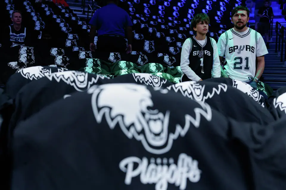 Borys, 13, and his father Arthur Sych watch the San Antonio Spurs warm up before Game 6 of the Western Conference semifinals against the Minnesota Timberwolves at Target Center in Minneapolis, Friday, May 15, 2026. The pair traveled from Winnipeg, Canada, to watch the game.